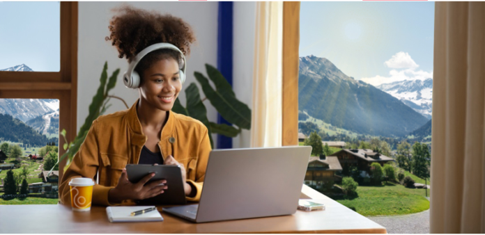 happy girl looking in her laptop swiss health insurance offers by hoi versicherung